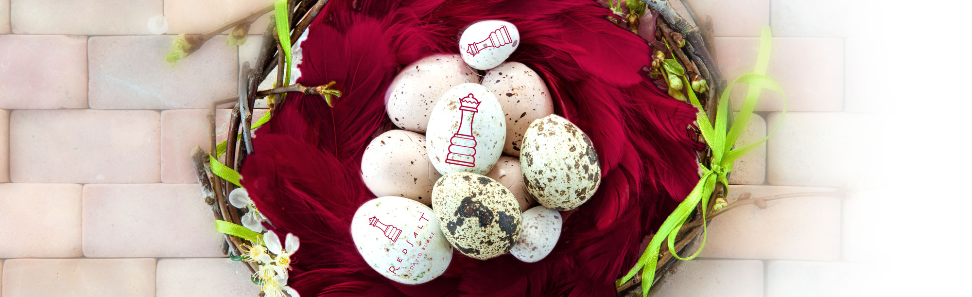 Easter eggs in feather basket with Red Salt by David Burke logo